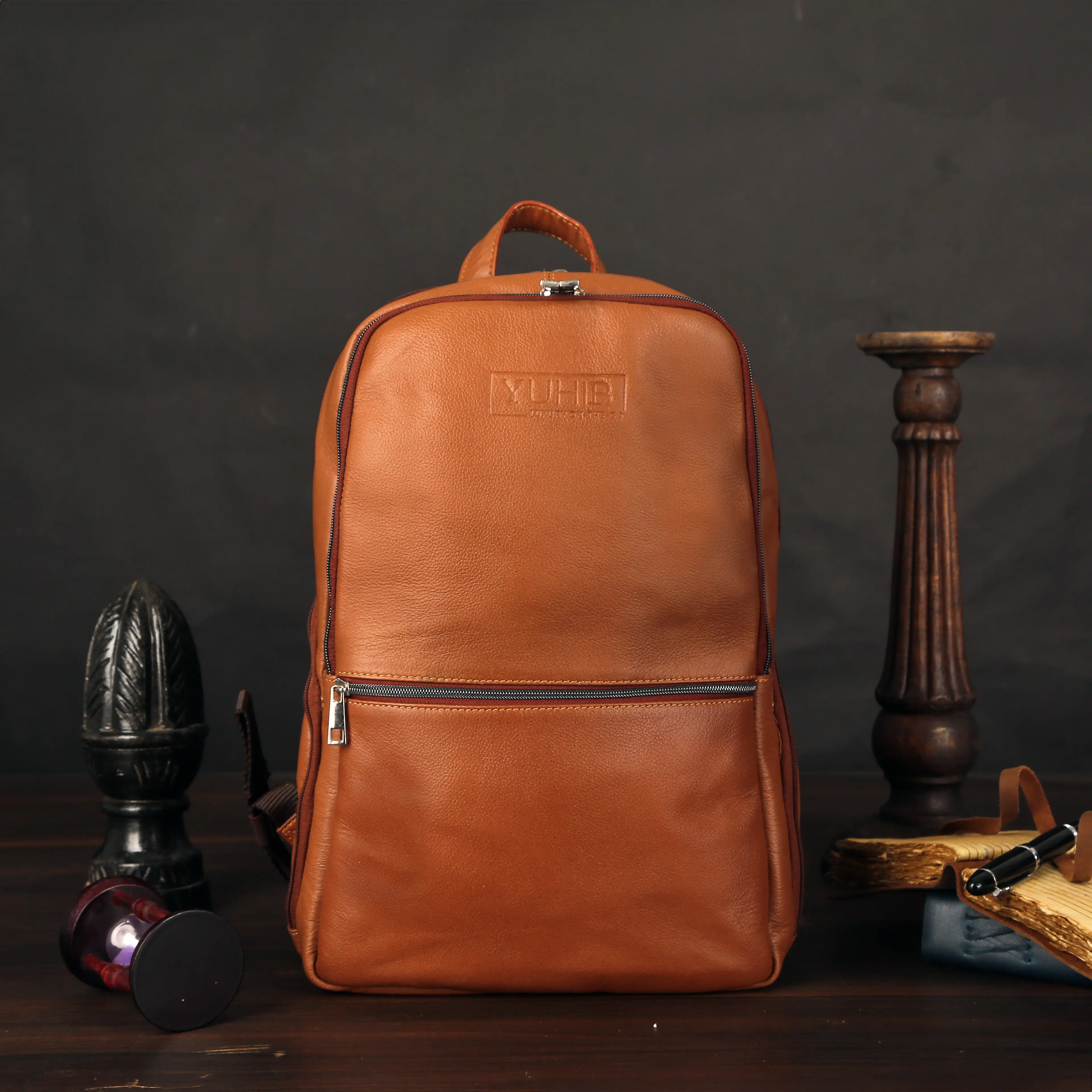 Tan leather backpack on dark backdrop — ecommerce product photography for marketplaces